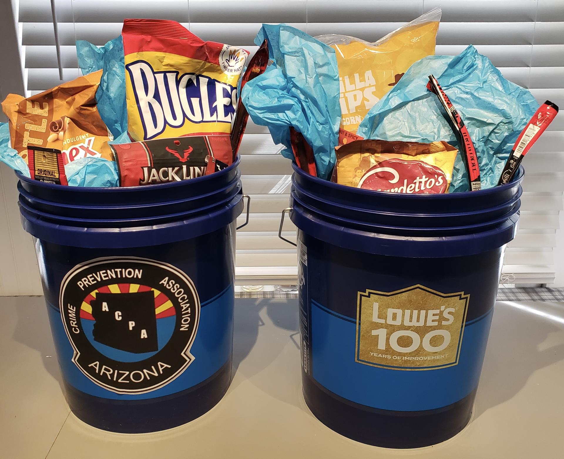 Photo of two buckets with GAIN night stickers filled with snacks