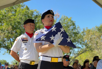 Military Veteran carrying folded American flag