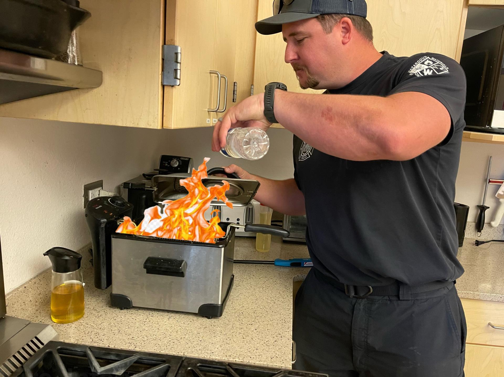 A firefighter pretending to put out a grease fire