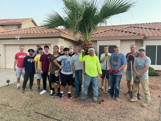 Group of volunteers in front of a house