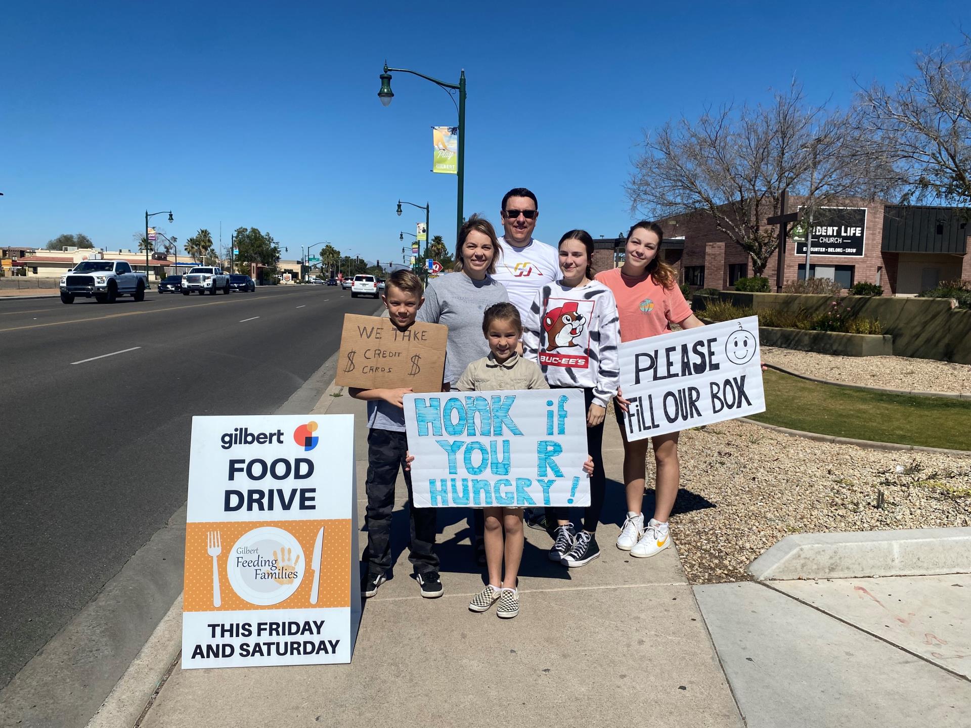 People holding signs to promote drive