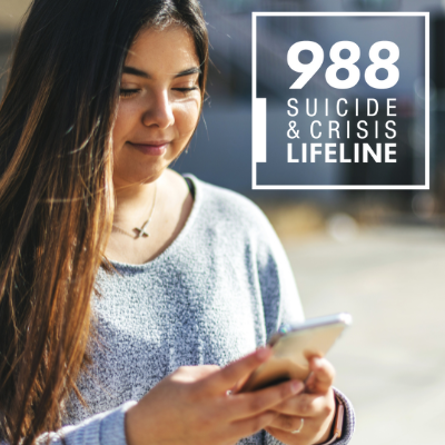 Photo of a woman holding her phone with the text 988 suicide and crisis lifeline text on the top right.