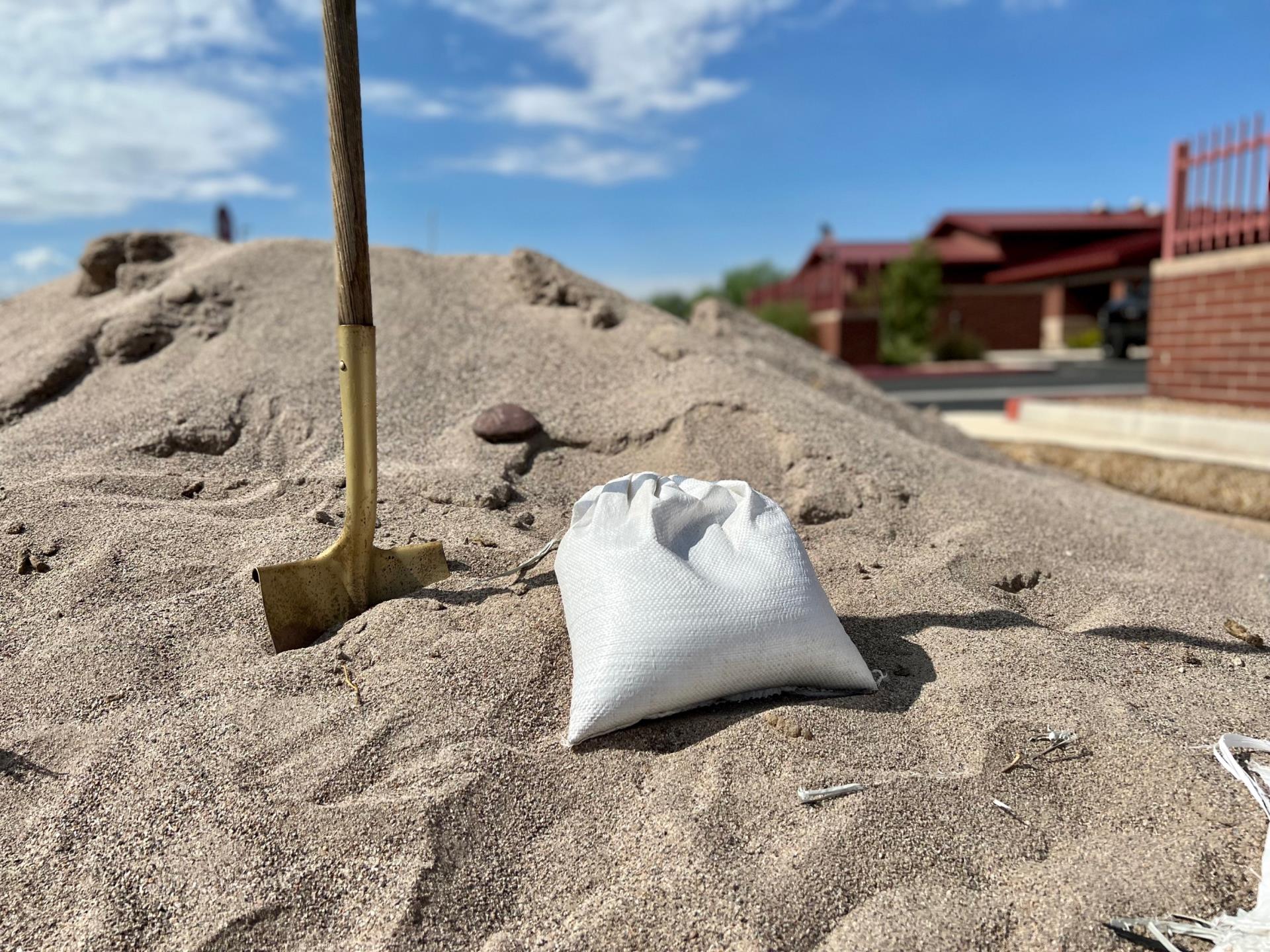 A pile of sand, a sandbag and a shovel sit outside a Gilbert fire station.