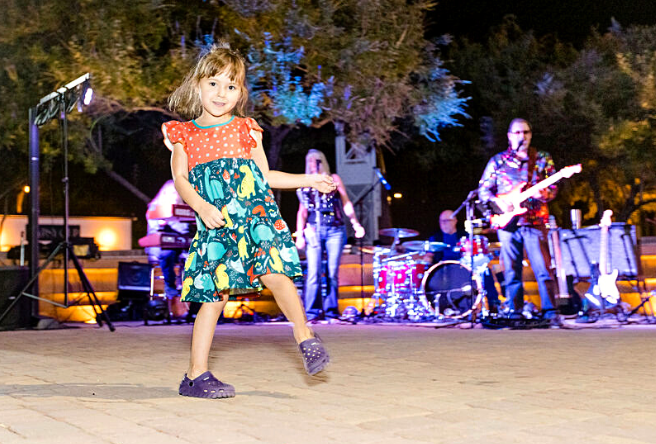 A young concert goer dances to the music at Water Tower Plaza.