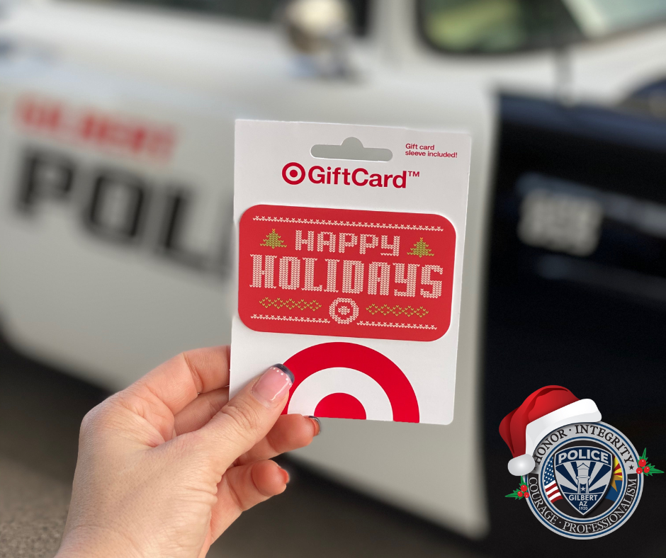 Image of a gift card with a police car in the background