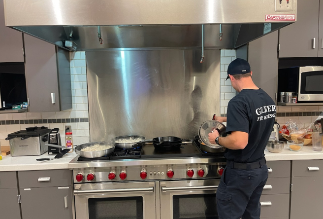 A firefighter cooking in the kitchen.