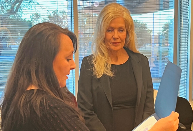 Gilbert Mayor Brigette Peterson presents newly-elected town councilmember Bobbi Buchli with a certificate following the official adoption of the results of the general election.