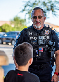 Photo of a police officer speaking with a child