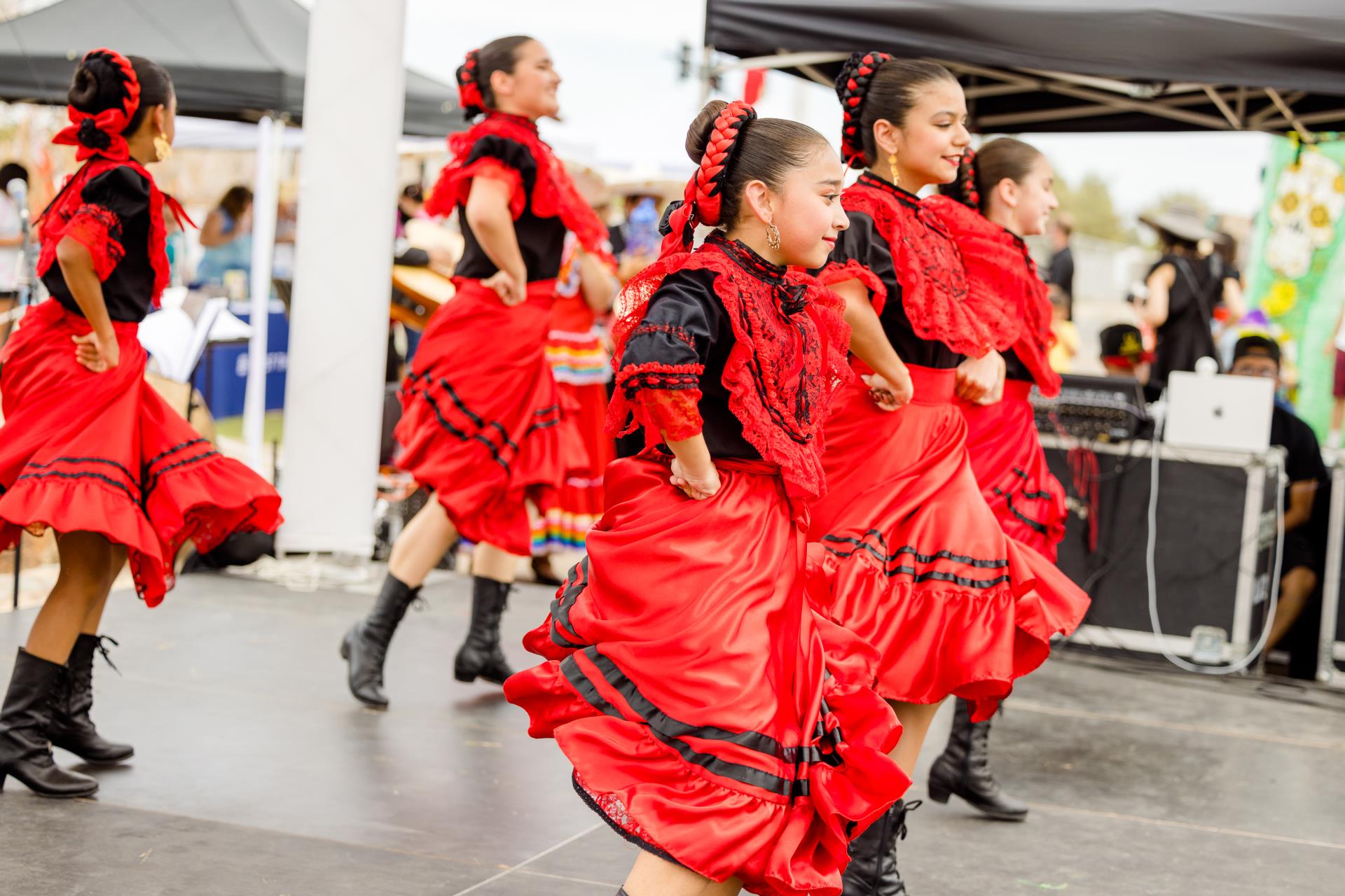 This is a photo of a Mexican Folklore dance group on stage at Global Village.