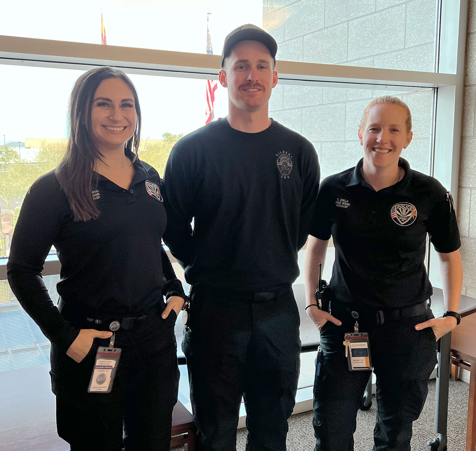 Gilbert PD's Three Crime Scene Specialists smile at the camera