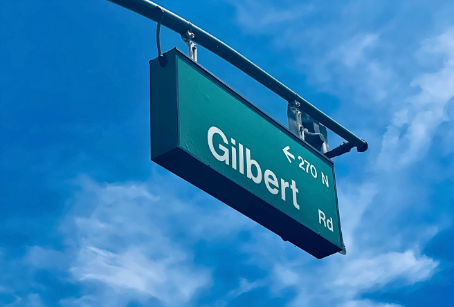 A photo of a Gilbert Road sign in downtown Gilbert.