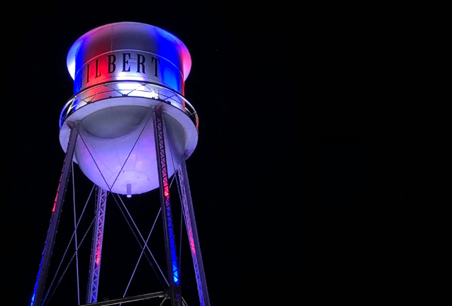 Gilbert's iconic water tower lit red, white and blue against the black night sky.