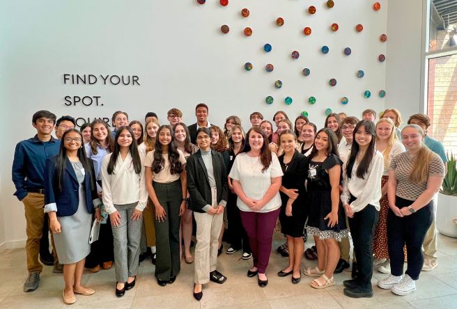 Mayor Brigette Peterson and a large group of high school students pose for a photo inside Gilbert Town Hall.