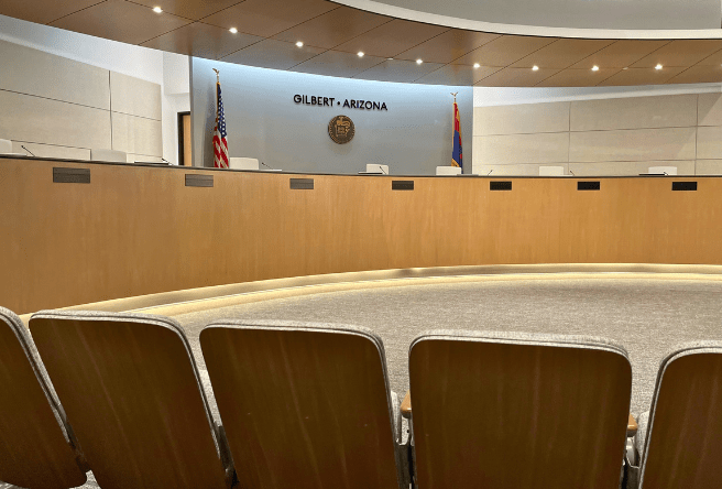 A medium shot photo of Gilbert Council Chambers showing the view of the dais from the audience.