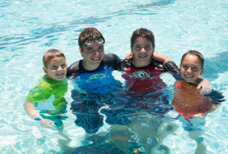 Four boys enjoy public swim at a Gilbert Pool