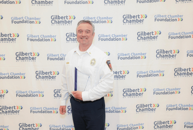 Gilbert Fire Chief Rob Duggan poses with his Gilbert Chamber of Commerce award.