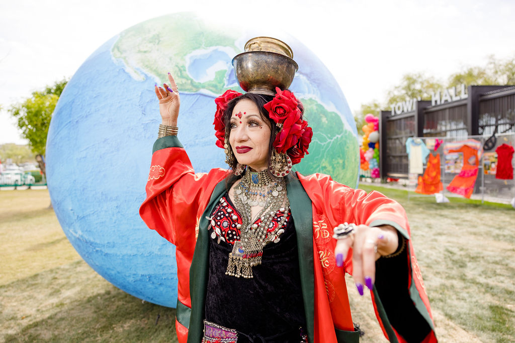 This is a photo of a dancer in front of an inflatable globe at Global Village. 