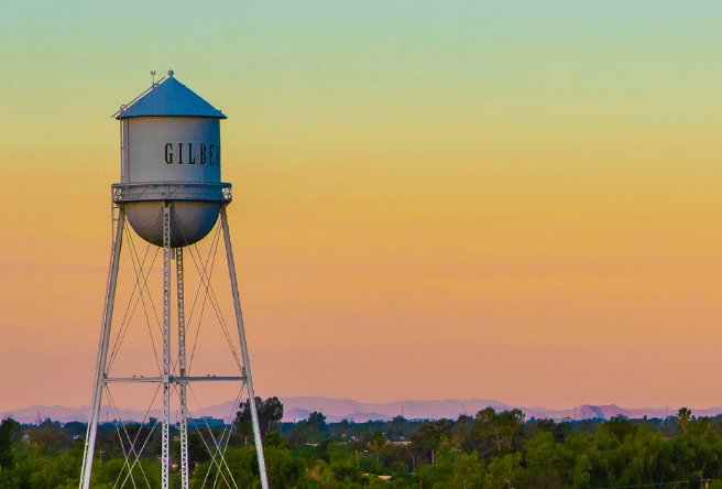 A wide camera shot of the Gilbert Water Tower with an orange and blue sky in the background.