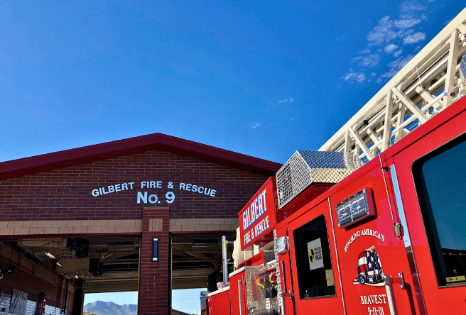 A tight photo from ground view showing the top of Gilbert Fire Station 9 and a fire apparatus.